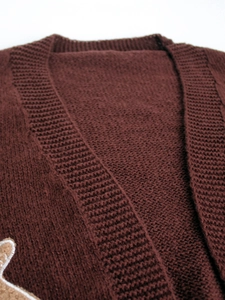 Deep brown V-neck knit cardigan with gingerbread man embroidery on white background