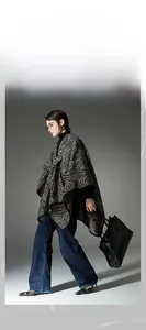 Detailed view of women's knitted shawl with zebra pattern and functional buckle closure