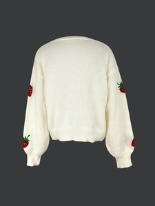 Detailed view of red strawberry embroidery on long sleeve cream knit cardigan