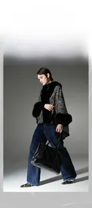 Detail of a zebra print shawl with plush black faux fur collar and textured fabric