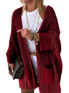 Detail of loose fit burgundy knit cardigan featuring large side pockets and ribbed cuffs