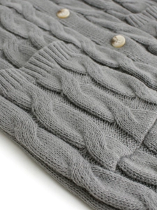 Long grey cable knit cardigan featuring premium weave texture and tortoise buttons