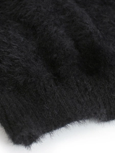 Close-up of soft black plush mohair knit fabric showing detailed fluffy texture