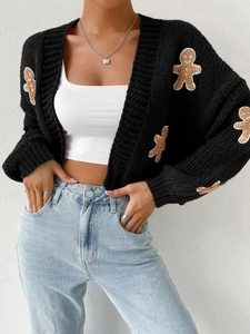 Close-up of black chunky knit cardigan featuring cute brown gingerbread man embroidery
