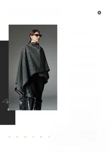 Detail shot of a grey herringbone knit poncho with black trim and sleek buckle closure