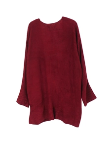 Detailed view of dark red oversized knitted sweater featuring ribbed cuffs and thick texture