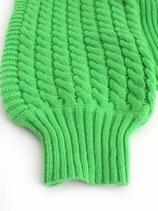 Bright green cable knit sweater featuring classic knit patterns and ribbed cuffs for women