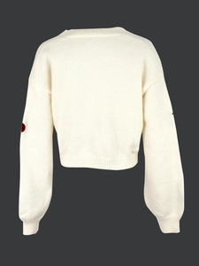 Detail view of the back of a cream knitted cardigan with elbow patches and ribbed cuffs