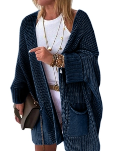 Detail of navy blue oversized knit cardigan featuring large pockets and cuffed sleeves