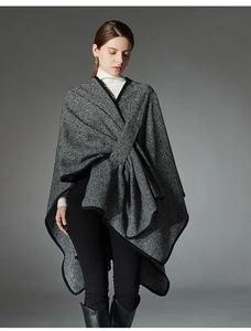 Close-up of black and white striped shawl wrap featuring refined black contrast piping