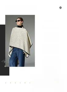 Detail of a beige knit shawl with black edges and high-end textured wool fabric finish