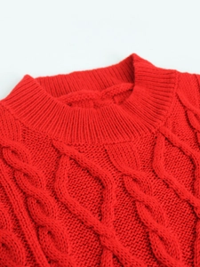 Close-up of vibrant red cable knit sweater featuring a round neck and thick diamond pattern