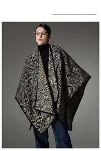 Detailed knit texture and zebra pattern of a thick winter shawl with buckle closure
