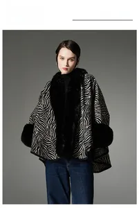 Detail shot of zebra pattern fabric and thick black faux fur collar on a winter shawl