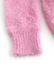 Detailed macro view of pink fuzzy knit sweater cuff with soft ribbed texture