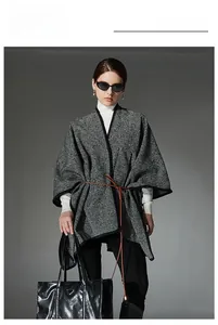 Detail of black and white diagonal striped shawl with a slim brown leather buckle belt