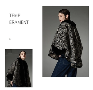 Detail view of the zebra-print hooded shawl featuring premium faux fur collar and knit fabric