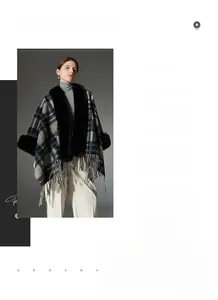 Detailed view of women's navy blue plaid poncho with faux fur collar and fringe hem