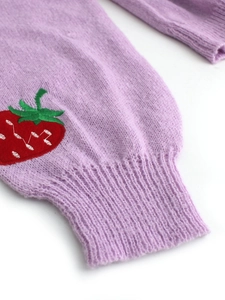 Detail of ribbed cuff on lavender knitted cardigan with red strawberry embroidery
