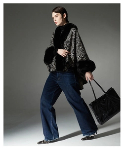 Detail view of winter zebra print shawl with plush black faux fur collar and cuffs
