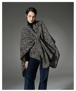 Detail of zebra stripe knit shawl with unique front knot design and buckle closure