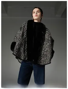 Detail shot of the zebra pattern texture and fluffy black faux fur collar on the cape