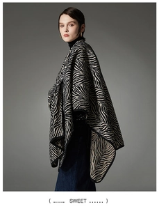 Detail of zebra pattern knitted shawl showing the thick fabric texture and drape