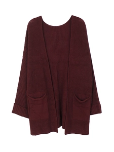 Detail view of burgundy chunky knit cardigan featuring large front pockets and ribbed cuffs