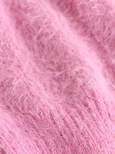 Close-up of soft pink mohair-like knit fabric with detailed vertical ribbed texture