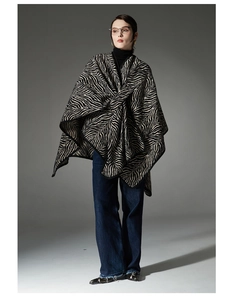 Detailed view of heavy zebra stripe shawl drape on model for autumn and winter style