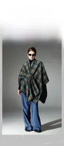 Detail of blue and brown plaid shawl with premium black stitched edges for winter styling