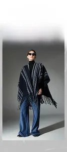 Detail of navy tassel shawl featuring white ethnic geometric patterns and soft woven texture
