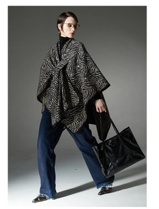 Detail of premium zebra pattern knitted shawl with buckle closure for women's winter wear