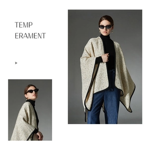 Detail of beige tweed shawl cardigan with black trim and elegant knit texture