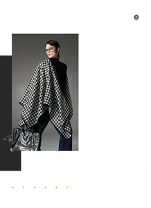 Detailed view of black and white houndstooth shawl with metallic buckle on a model