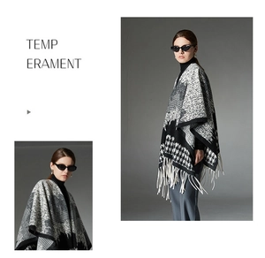 Detail of black and white houndstooth knit shawl featuring long white fringe accents
