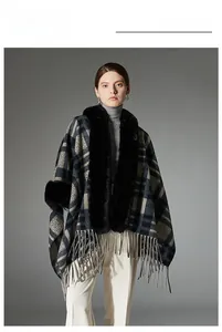 Detail of navy blue plaid poncho with faux fur collar and fringe hem on model
