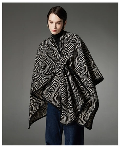 Detailed view of women's thick zebra print shawl cape with buckle closure for winter fashion