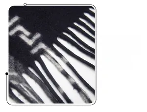 Detail of black and white jacquard shawl showing thick texture and long tassel fringe