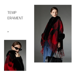 Detailed view of the red and black plaid poncho with faux fur trim and long tassels