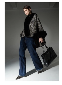 Detail showing high-quality zebra pattern cape with faux fur collar and sleeve cuffs