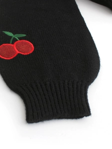 Detail of ribbed cuff on black knitted jacket with premium cherry embroidery texture