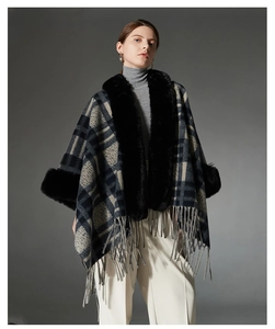 Detailed view of winter plaid shawl with faux fur collar and fringe tassels in navy blue
