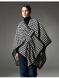 Detailed view of women's black and white houndstooth shawl with classic buckle closure