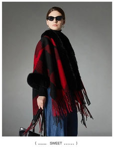 Detail of red and black checkered shawl featuring plush black faux fur and fringe hem