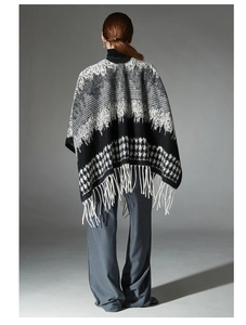 Detail of black and white houndstooth wool shawl featuring woven tassels on back side