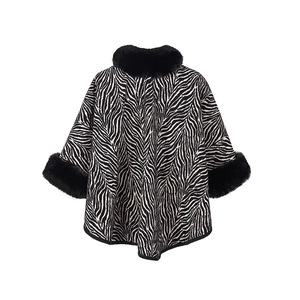 Detail of zebra print shawl with thick black faux fur collar and knit texture