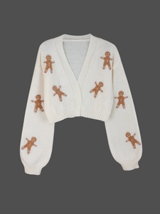 Close-up of ginger man embroidery details on cream-colored short knit cardigan sweater