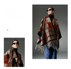 Detail view of plaid wool shawl with orange fringe edges and soft knit texture