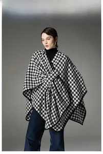Detail of classic black and white houndstooth poncho with soft premium fabric texture